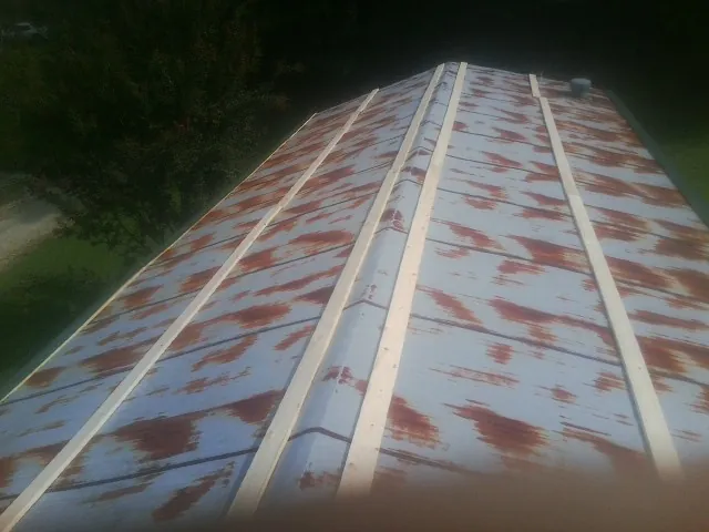 Rusted metal roof panels with new wood purlins before replacement — Storm Damage Roof Repair in Bangor by Roofing Brothers